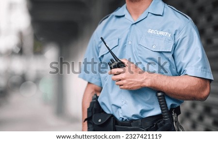 Walkie talkie, security guard or safety officer man on the street for protection, patrol or watch. Law enforcement, hand and duty with a crime prevention male worker in uniform in the city Royalty-Free Stock Photo #2327421119