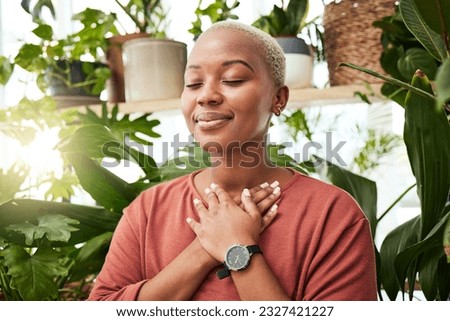 Balance, breathing and young woman by plants for zen meditation in a greenery nursery. Breathe, gratitude and young African female person with a relaxing peace mindset by an indoor greenhouse garden. Royalty-Free Stock Photo #2327421227