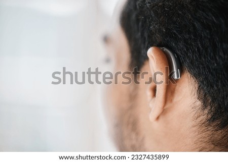Hearing aid, closeup or ear of man with disability from the back on mockup space. Deaf person, medical device or implant of sound waves, audiology or help of listening equipment, accessory or support Royalty-Free Stock Photo #2327435899
