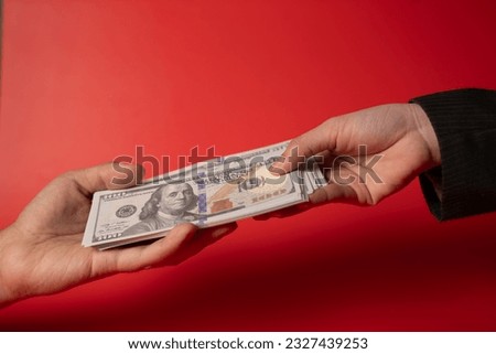 Hands holding dollar bills, People sending and receiving banknotes for doing business, Customer bringing money for deposit to bank, Many hundred dollar bills and banknotes for corruption bribe