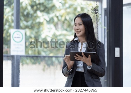Portrait of asian business woman holding a digital tablet and standing in creative office, Successful businesswoman.