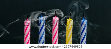Vibrant Celebrations: Close-Up of Colorful Birthday Candle Flames Against a Black Background, Illuminated in Captivating 4K Resolution