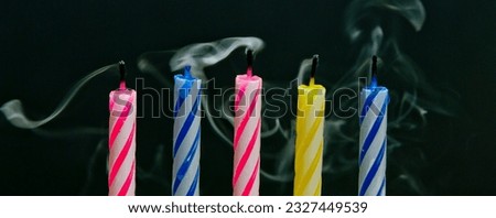 Vibrant Celebrations: Close-Up of Colorful Birthday Candle Flames Against a Black Background, Illuminated in Captivating 4K Resolution