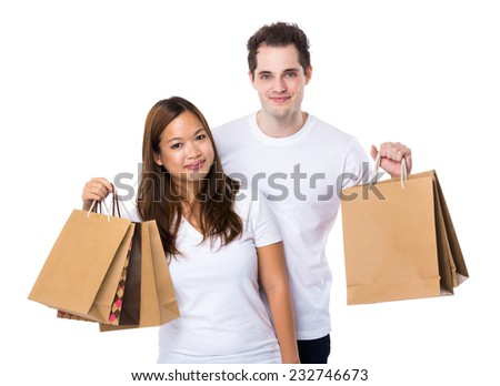 Asian woman and caucasian man holding shopping bag together