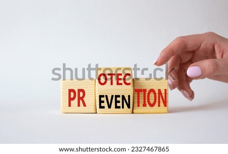 Protection and Prevention symbol. Businessman hand points at wooden cubes with words Prevention and Protection. Beautiful white background. Business concept. Copy space