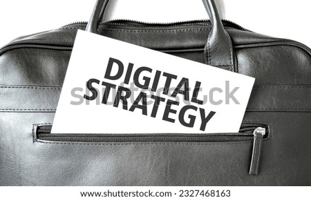Text DIGITAL STRATEGY writing on white paper sheet in the black business bag. Business concept