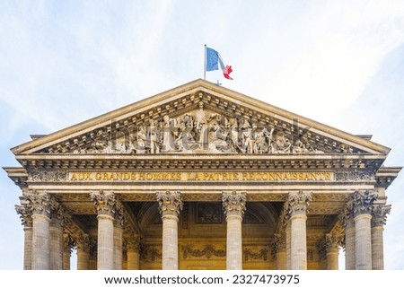 Front view of Tympanum and massive ancient columns of Pantheon in Paris, France