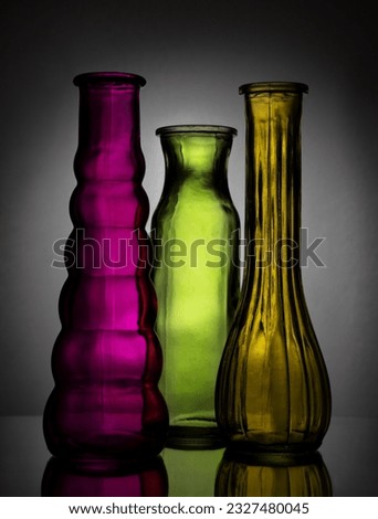 Colored bottles of different shapes with a vignetting effect.