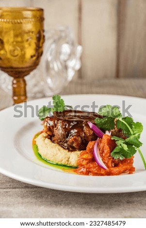 Сlose up picture filet medallions served with mashed potatoes and demiglas sauce. Beef medallions or mignon and vegetable puree