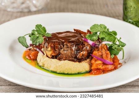 Сlose up picture filet medallions served with mashed potatoes and demiglas sauce. Beef medallions or mignon and vegetable puree