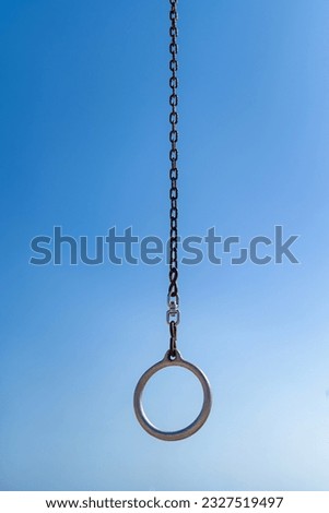 Gymnastic ring on a blue sky background