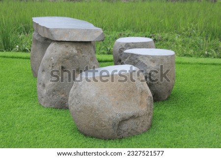 
Tables and chairs were made of stone, the tops were leveled smooth. Sturdy and looks natural.
