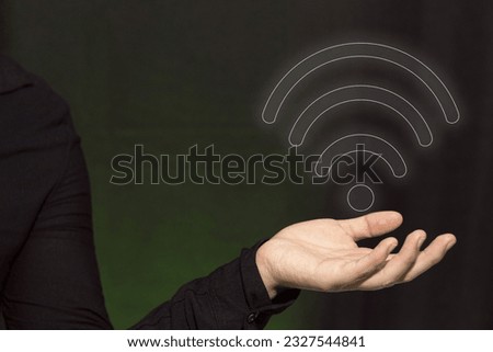 A businessman holding a free wifi symbol. Internet network. Connectivity concept.