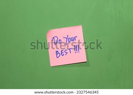 The motivational slogan "Do Your Best" Note pads pasted on a green wall background