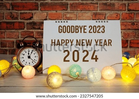 Happy New Year 2024 text message with alarm clock and LED cotton balls decoration