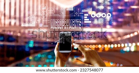 Micropayments theme with big city lights at night Royalty-Free Stock Photo #2327548077