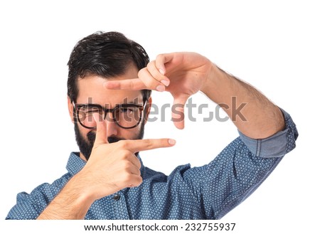Young hipster man focusing with his fingers