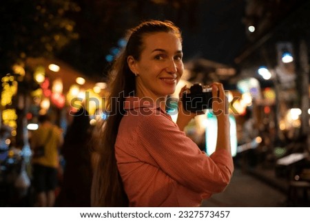 Tourist woman enjoy traveling take photo in city lifestyle chinatown street food market Bangkok, Thailand.