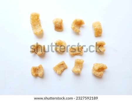 Homemade Fatty pork snack, pork rind, pork scratching, pork crackling  isolate on a white backdrop.Thai snacks and Popular traditional food
 Royalty-Free Stock Photo #2327592189
