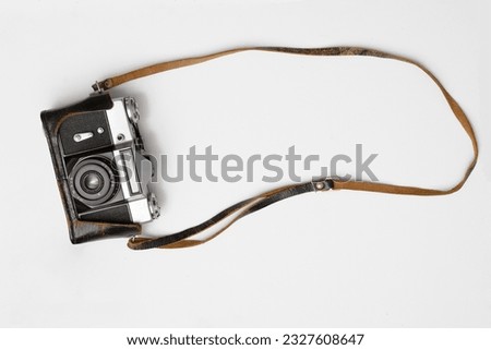 one Old, aged film camera in black leather cases isolated on white background. 1 Vintage soviet union photo camera. made in USSR.