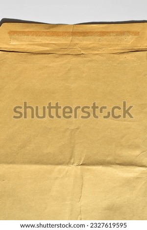 Brown and beige cardboard paper mail envelope on a white background. Can be used in company correspondence
