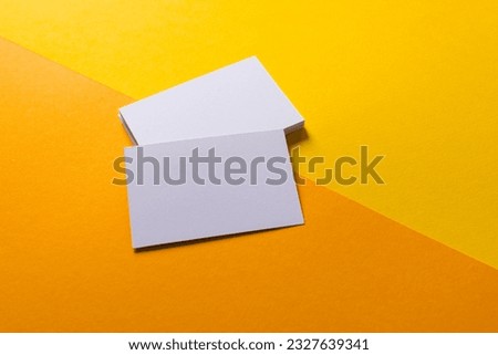 White business cards with copy space on yellow and orange background. Business, business card, stationery and writing space concept.