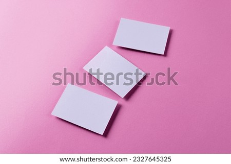 White business cards with copy space on pink background. Business, business card, stationery and writing space concept.
