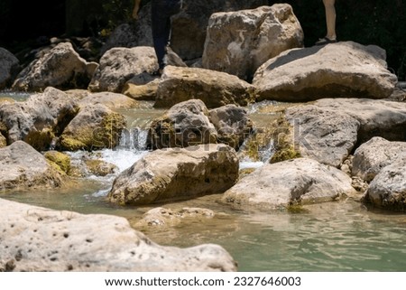  Small waterfall flowing through the stones in the creek                              