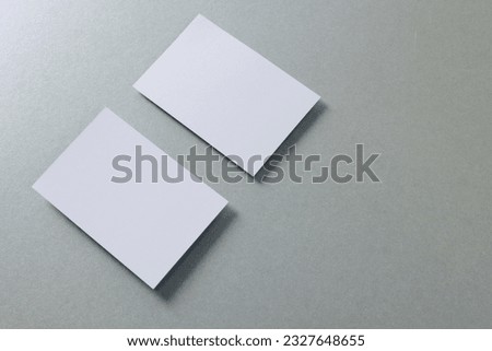 White business cards with copy space on grey background. Business, business card, stationery and writing space concept.