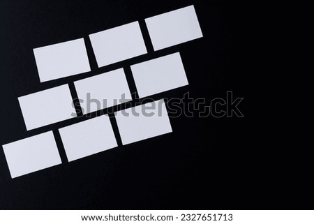 White business cards with copy space on black background. Business, business card, stationery and writing space concept.
