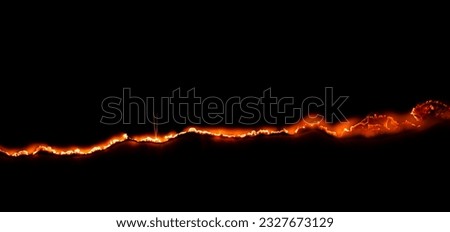 burning paper, glowing edge of paper on a black background Royalty-Free Stock Photo #2327673129