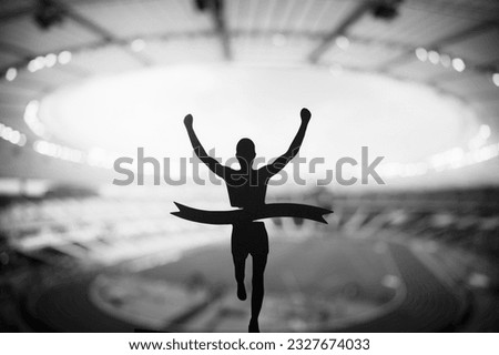 Black and Field Athletics photo. Triumph of Speed: Silhouette of Runner Soars to Victory at Modern Athletics Stadium. Edit Space, Track and Field Competition Photo.