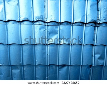 Blue zinc wall exposed to sunlight