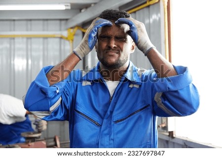 worker or technician feeling tired and have a headache in the factory