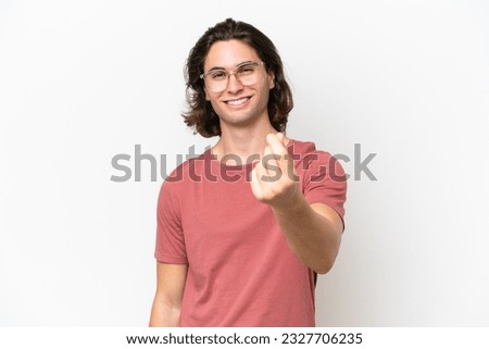 Young handsome man isolated on white background making money gesture