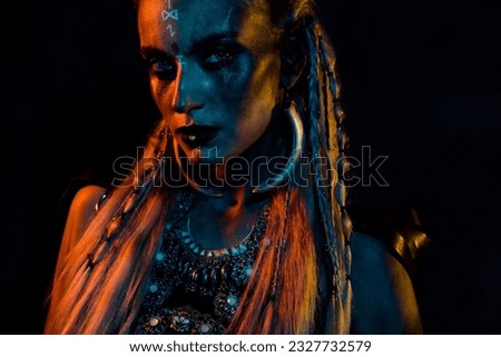 Cropped photo of scary ancient viking shield maiden girl painted face jewelry accessory isolated on black background