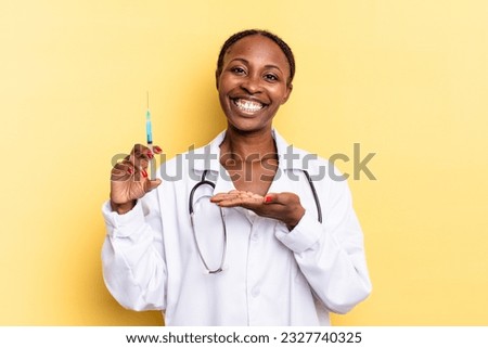 smiling cheerfully, feeling happy and showing a concept in copy space with palm of hand. physician and syringe concept