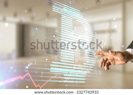Double exposure of male hand working with creative Bitcoin symbol hologram on blurred office background. Mining and blockchain concept