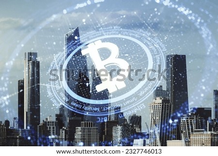 Double exposure of creative Bitcoin symbol hologram on New York city skyscrapers background. Cryptocurrency concept