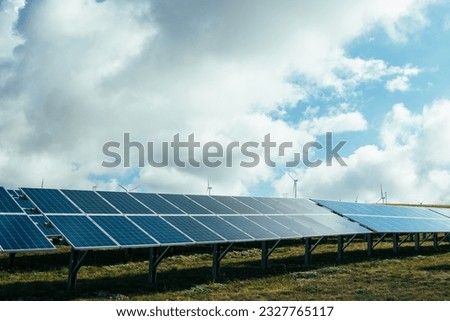 Conceptual photo of eco-sustainable technologies and industry 2.0. A solar power plant with photovoltaic panels in the countryside in nature for clean energy against coal and fossils