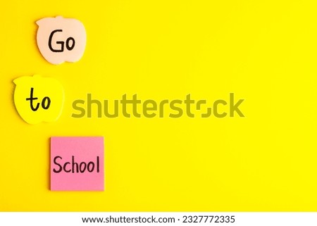 front view different colored stickers with go to school writing on the yellow desk school color photo children