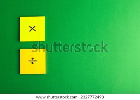 front view different signs on colored stickers on the green background math color science calculation school photo