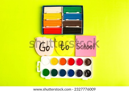 front view different colored stickers with go to school writing plasticine and paints on the green background school color photo children sticker