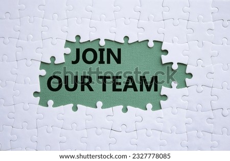 Join our team symbol. White puzzle with words Join our team. Beautiful grey green background. Business and Join our team concept. Copy space.