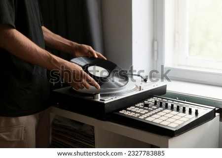 man changing record on vinyl player Royalty-Free Stock Photo #2327783885