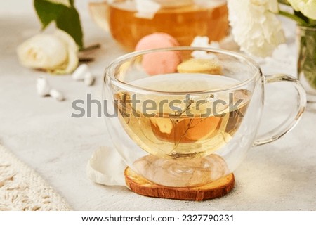 Tea cup, audiohealing, stress relief and earphones. Herbal tea, aesthetic tea time. Feminine, meditative calm lifestyle. Royalty-Free Stock Photo #2327790231