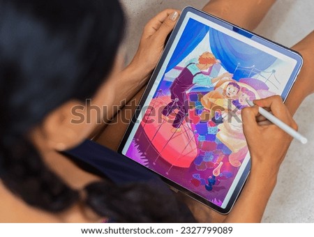 Brunette woman artist and illustration drawing, using electronical tablet and stylus, by using touchscreen