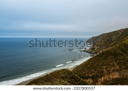 Seascape view from the Tomales Point Trail in Point Reyes National Seashore, Marin County, California, USA,  on a partly cloudy day at low tide, featuring  a trail and a rock at the end of it Royalty-Free Stock Photo #2327800537