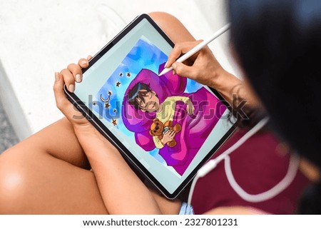 Brunette woman artist and illustration drawing, using electronical tablet and stylus, by using touchscreen Royalty-Free Stock Photo #2327801231