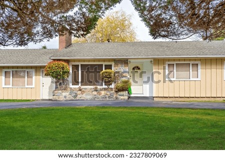 Modest residential duplex house in Canada with green lawn in front Royalty-Free Stock Photo #2327809069